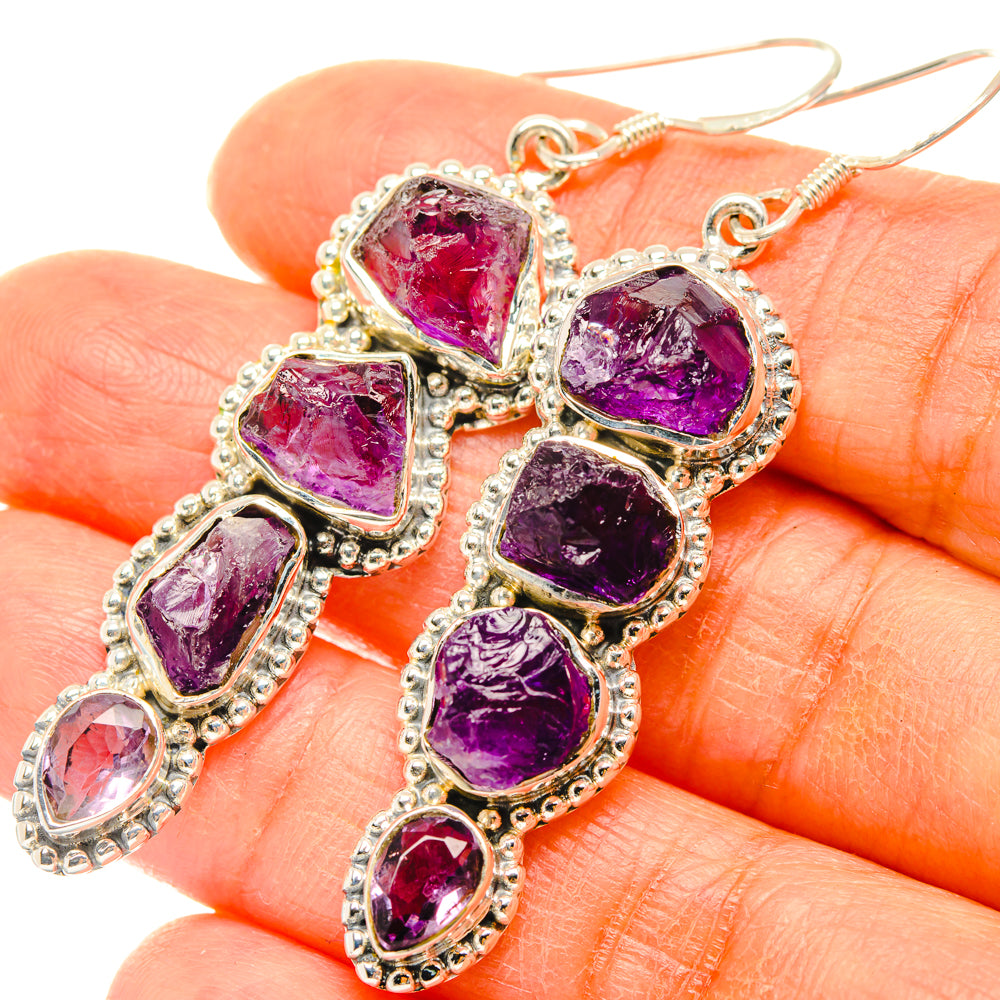 Close-up rough amethyst dangle earrings, textured sterling silver settings