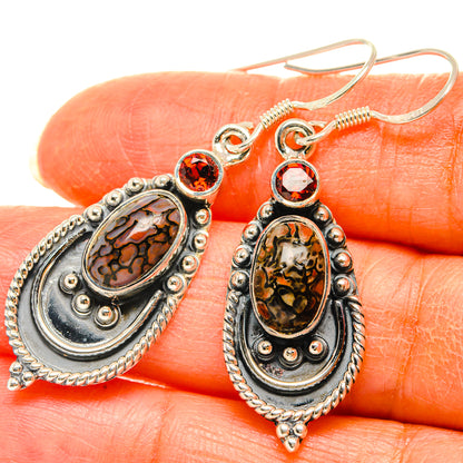 Garnet dinosaur bone earrings on oval stone settings, red round accents in silver