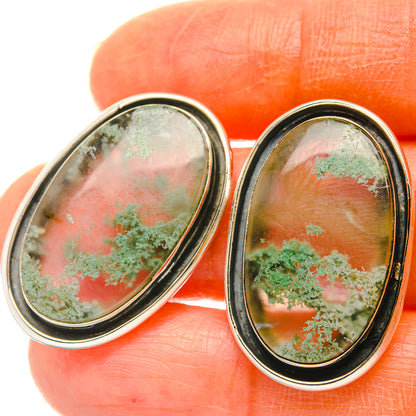 Oval green moss agate stud earrings in 925 sterling silver bezel, angled close-up