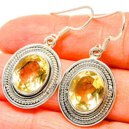 Close-up: sterling silver oval drop earrings with faceted citrine center and bead trim
