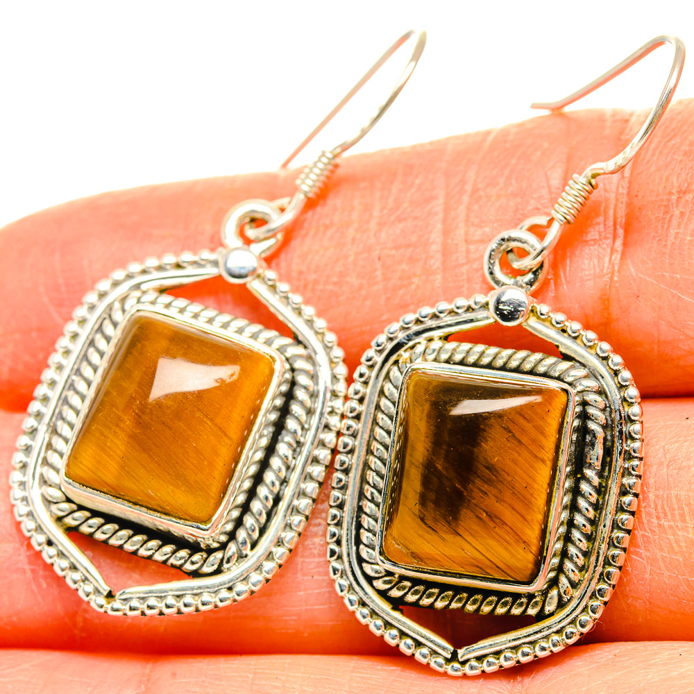 Amber tiger-eye earrings with ornate square silver settings and fishhook backs