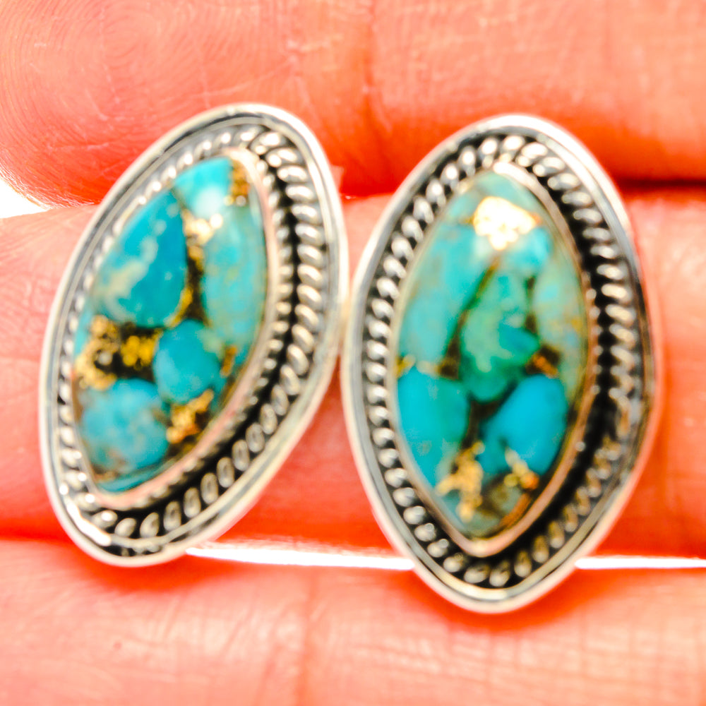 Close-up of 925 sterling silver turquoise oval earrings with gold fleck inlay detail