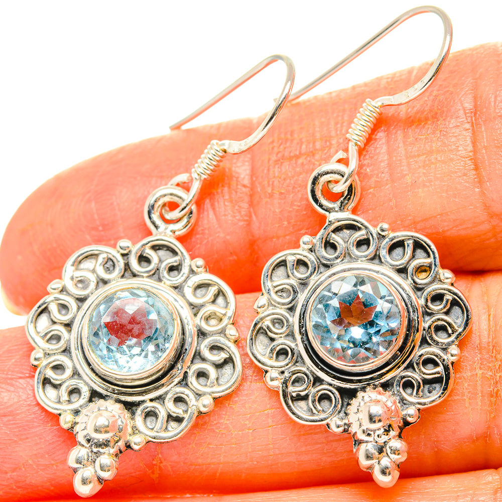 Blue topaz drop earrings in sterling silver with ornate round filigree and dangling beads