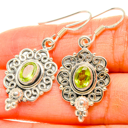 Sterling silver peridot filigree drop earrings with round halo and small dangling bead charms