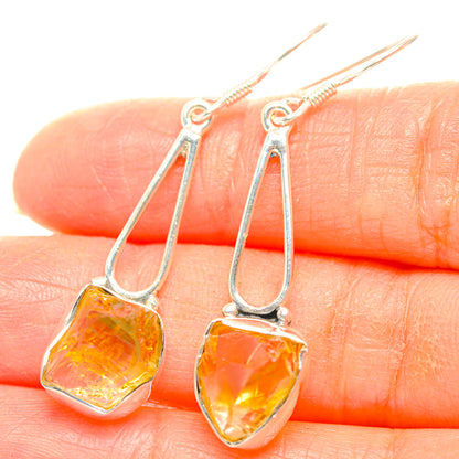 Sterling silver earrings with rough citrine teardrop stones, open hoop dangle