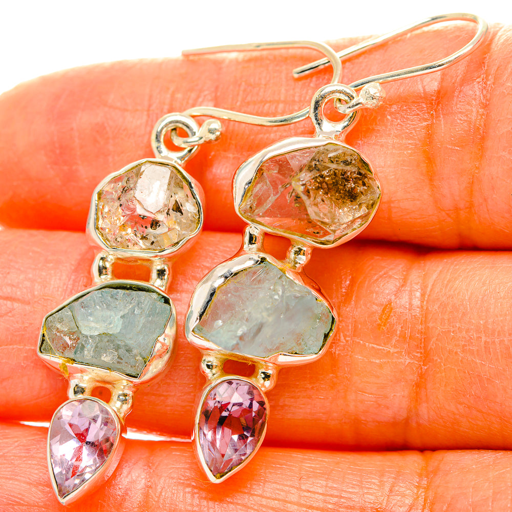 Silver-tone dangling earrings with faceted clear, green, pink, and blue gemstone drops
