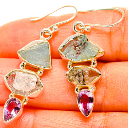 Gemstone drop earrings with blue-green and clear stones, plus purple teardrop accents