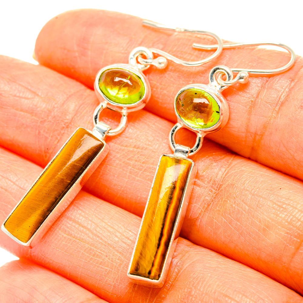 Sterling silver drop earrings with peridot-green round stones and tiger-eye bars