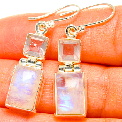 Close-up of 925 sterling silver dangle earrings with two square iridescent pink stones
