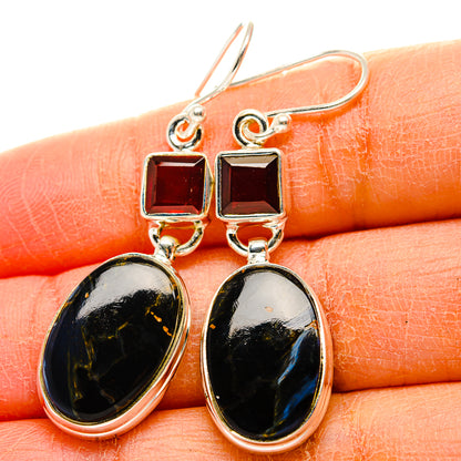Sterling silver earrings close-up: red square tops with black oval pietersite drops