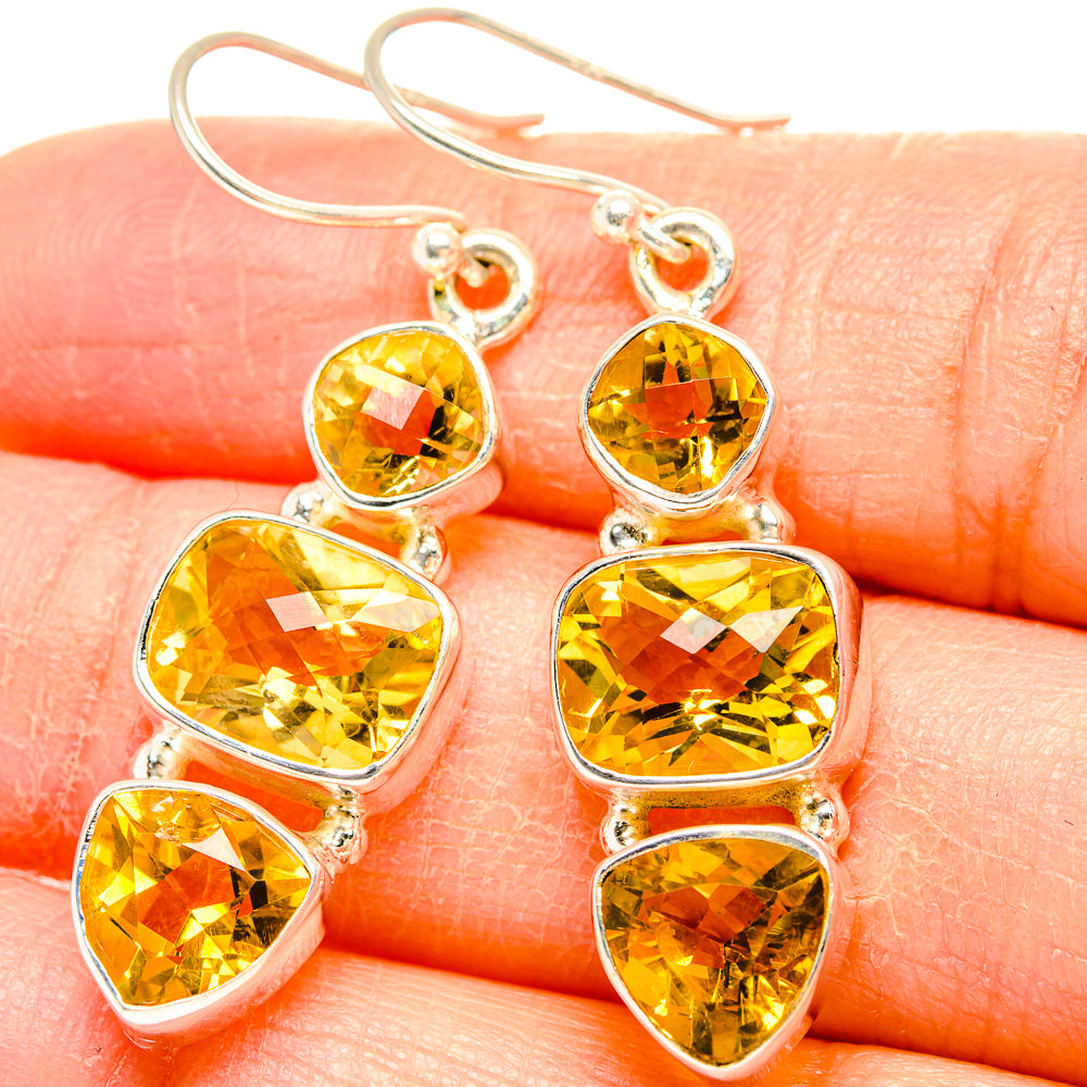 Faceted citrine drop earrings in 925 sterling silver with three faceted golden stones, close-up