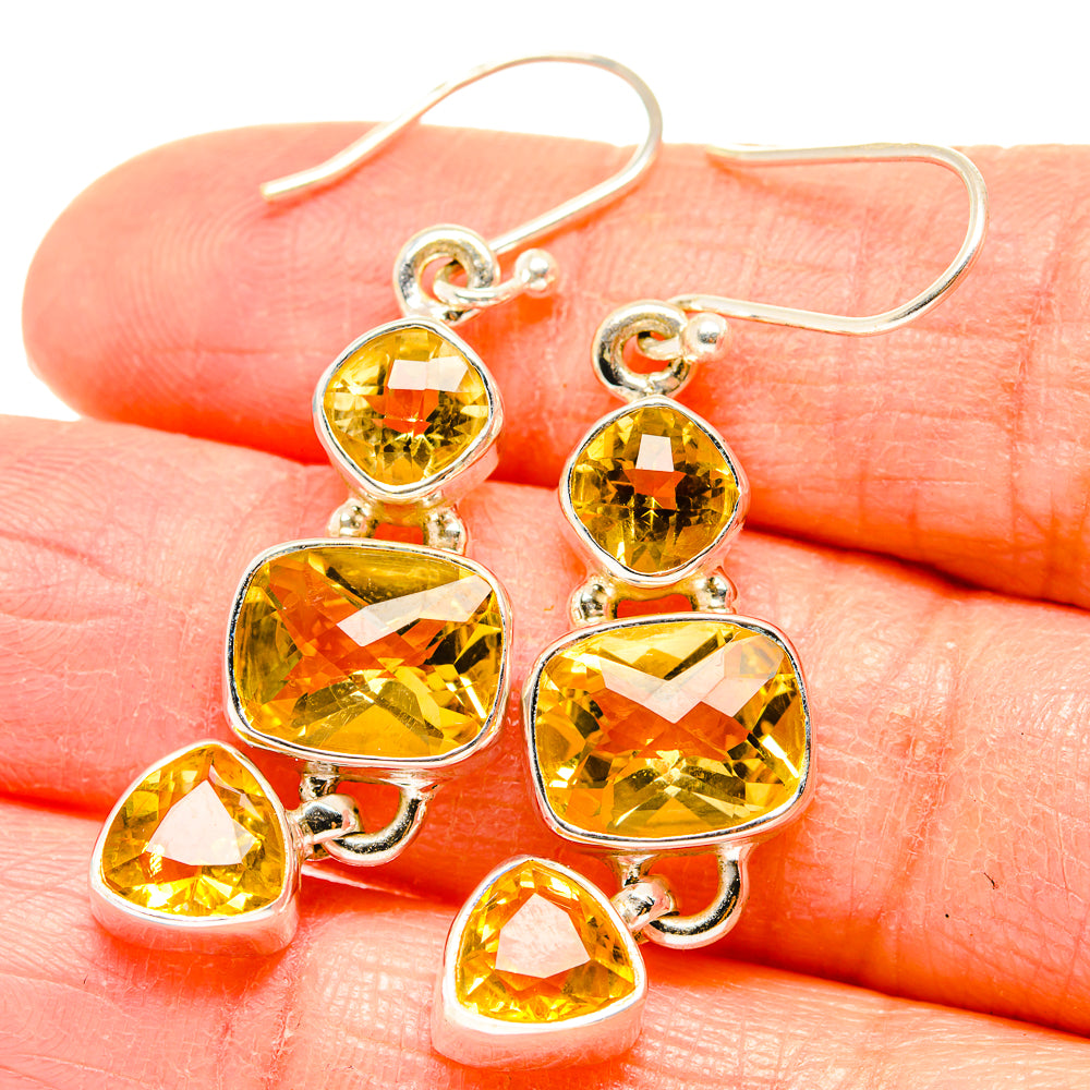 Sterling silver citrine earrings with faceted yellow heart and teardrop charms, dangling