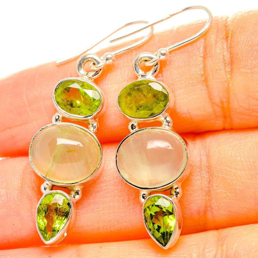 Sterling silver dangle earrings closeup: green oval and teardrop gemstones with pale rounds