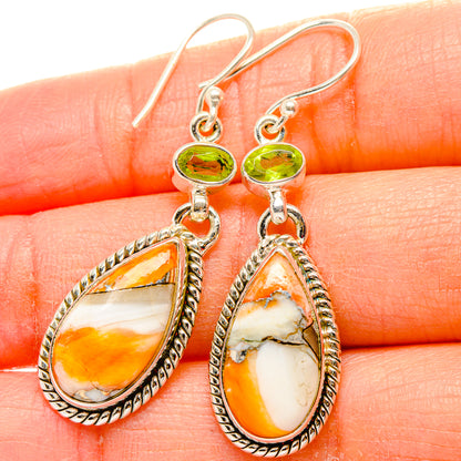 Sterling silver dangle earrings with green round stones and orange teardrop drops