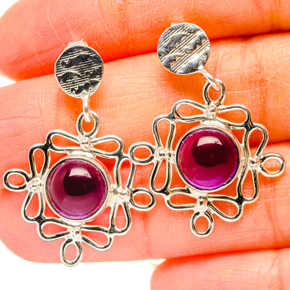 Silver amethyst earrings with round purple cabochon stones and ornate drop frames