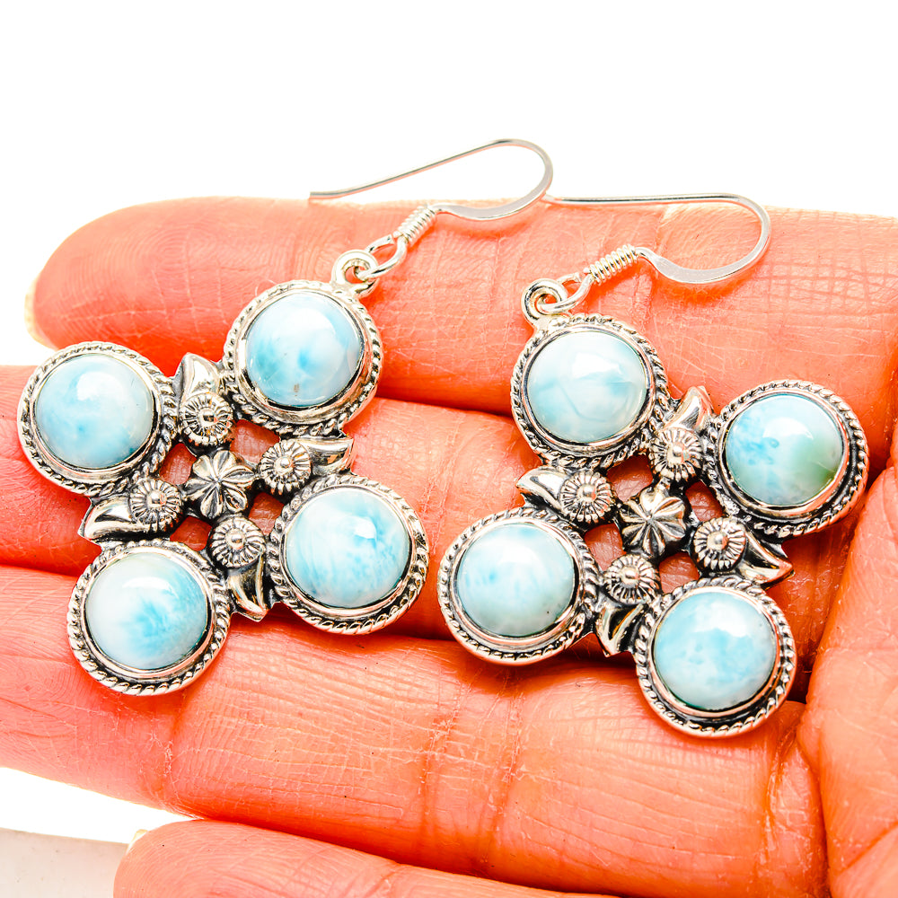 Sterling silver larimar cross earrings, close-up showing six light-blue round stones