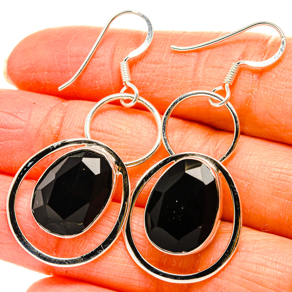Black onyx drop earrings: oval faceted stone in silver halo with fishhook backs.