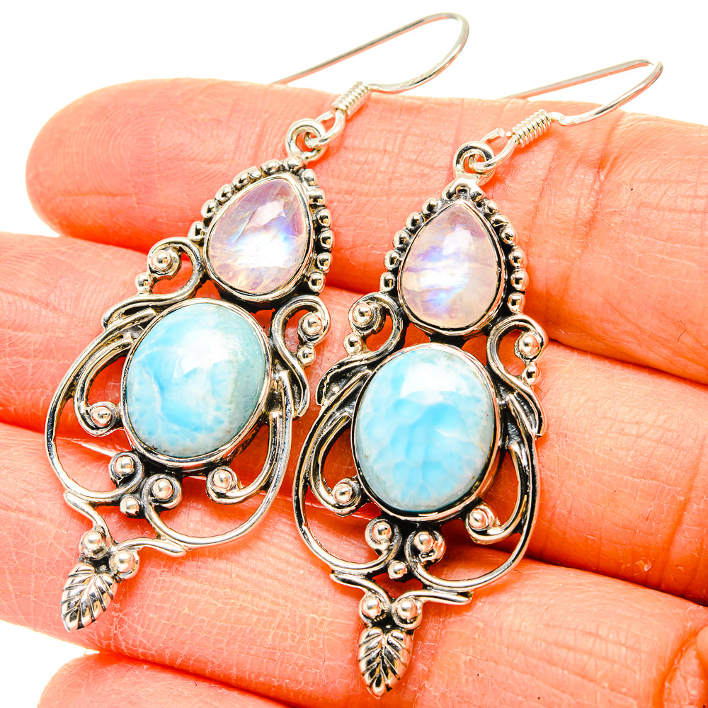 Sterling silver drop earrings with opalescent and light-blue oval gemstones, leaf charms