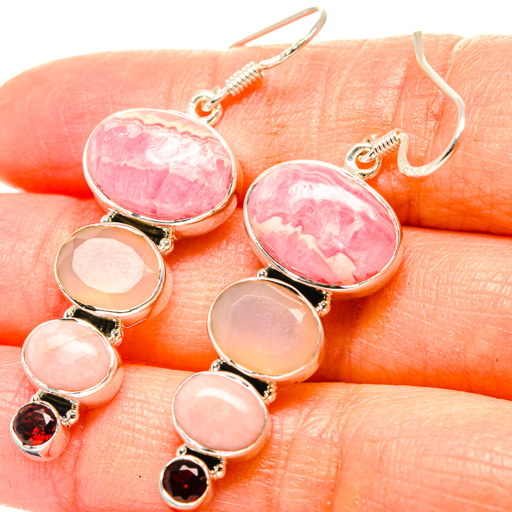Gemstone drop earrings: oval pink stones with small red garnet accent, silver-tone hooks