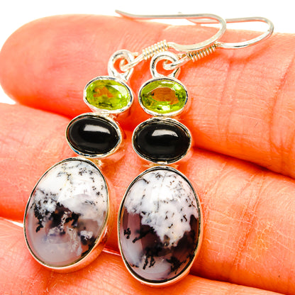 Sterling silver drop earrings with green peridot, black onyx, and white dendritic opal.