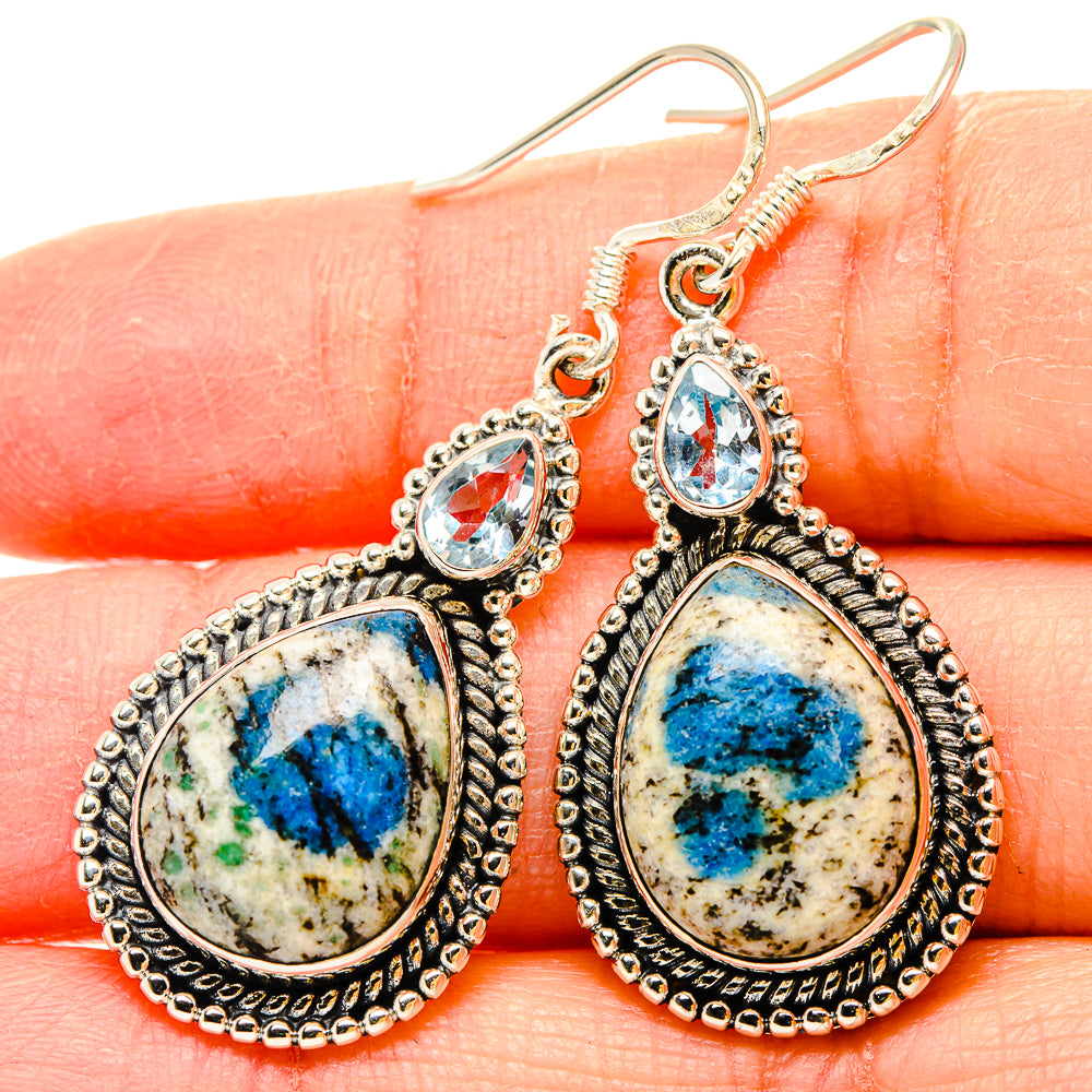Sterling silver dangling earrings: small blue oval and large teardrop stones, scalloped trim