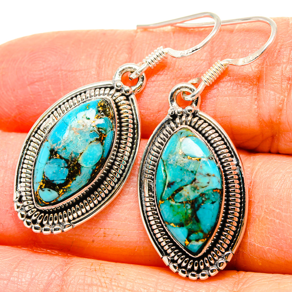 Turquoise oval cabochon drop earrings with detailed sterling silver border and hook backs