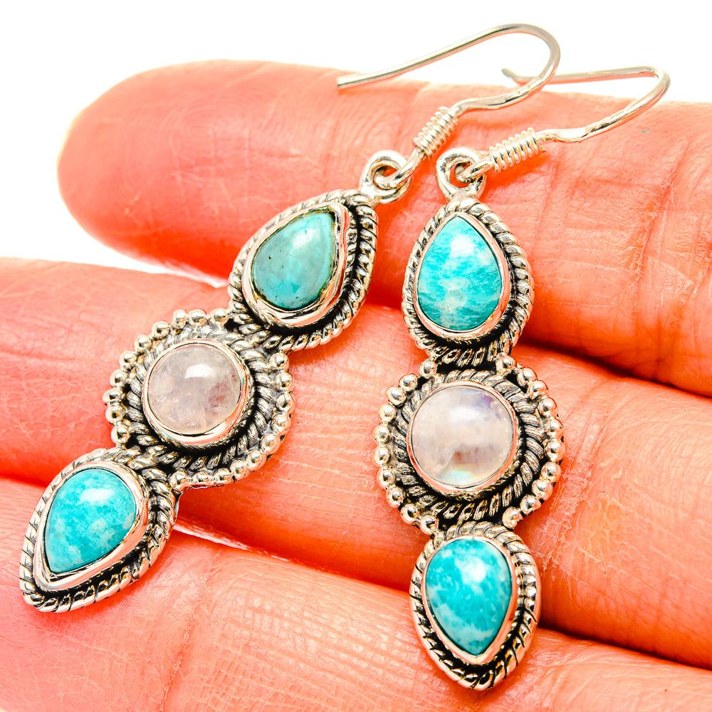 Sterling silver drop earrings featuring turquoise teardrop and pearl moonstone-style discs