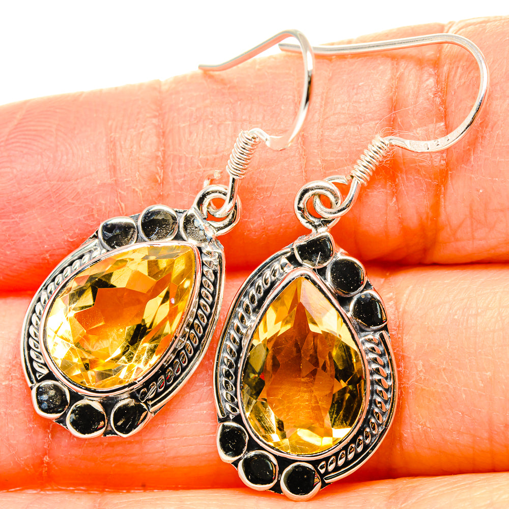 Sterling silver citrine drop earrings with faceted yellow oval stones and black bead border