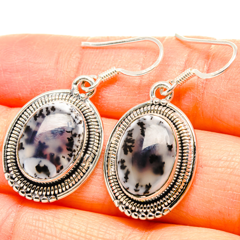 Sterling silver oval dendritic opal drop earrings with textured border and fishhook backs