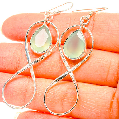 Sterling silver drop earrings with greenish aqua teardrop stone and looped design