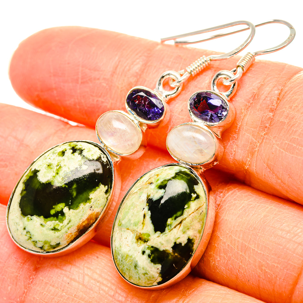 Sterling silver drop earrings with green oval stones, iridescent round accents, and purple tops