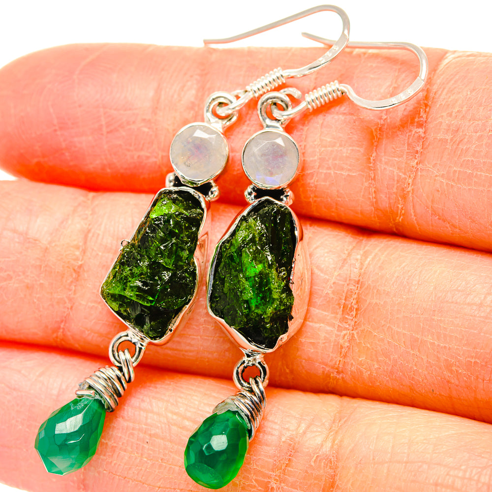 Sterling silver earrings close-up with oval green rough stones and green bead drops