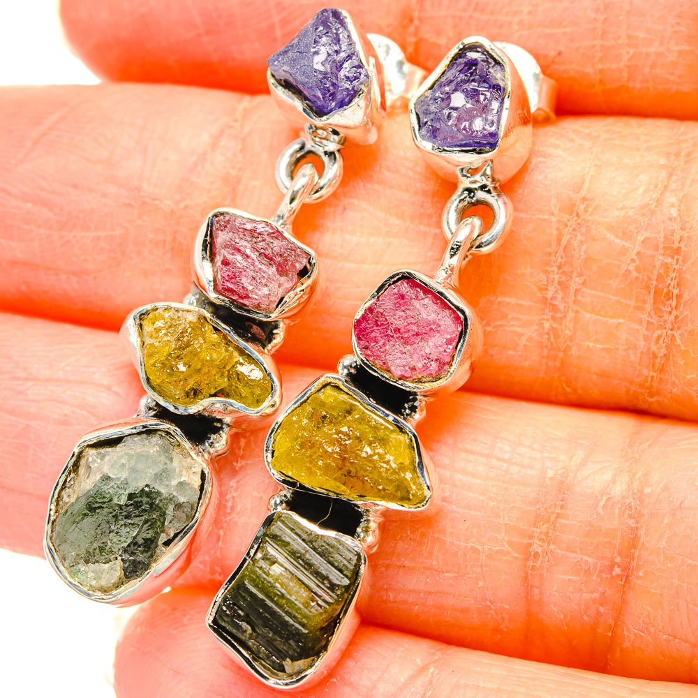 Close-up rough drop earrings: purple and pink stones with yellow and green pieces