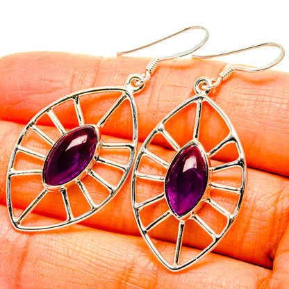 Sterling silver amethyst drop earrings with oval purple gemstone in a fan-spoke frame
