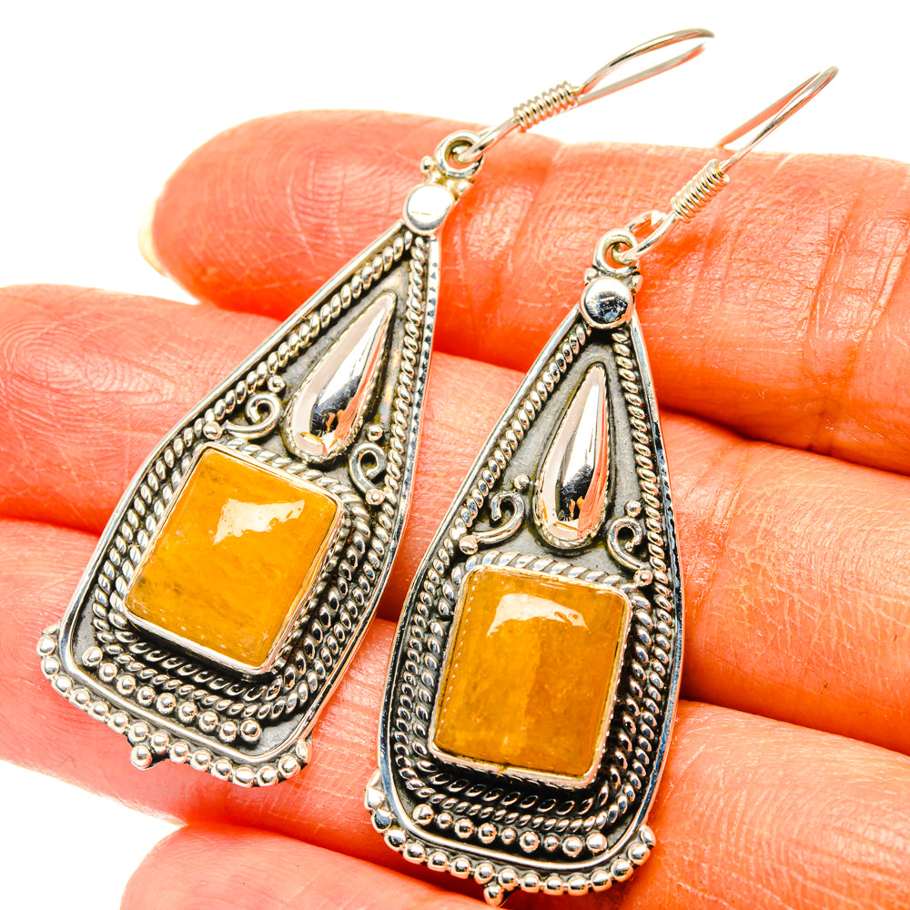 Ornate silver drop earrings with square citrine cabochon and blue stone tops