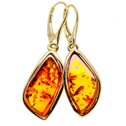 Amber teardrop dangle earrings with gold-tone frames and lever-back hooks