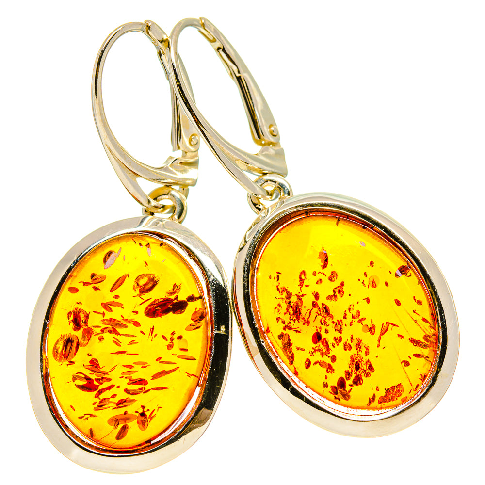 Gold-tone amber drop earrings with oval amber cabochons in halo bezels, lever hook backs