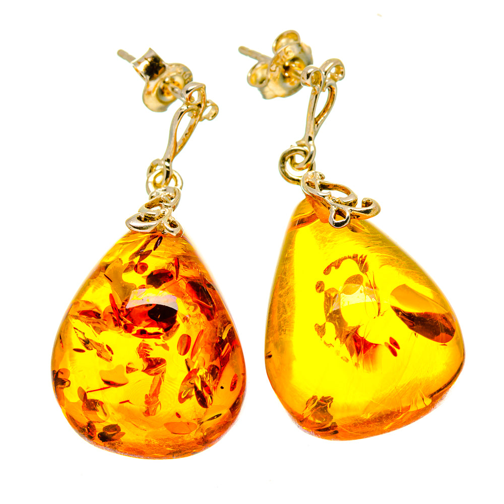 Pair of amber teardrop earrings with gold-tone hooks and faceted Baltic amber drops