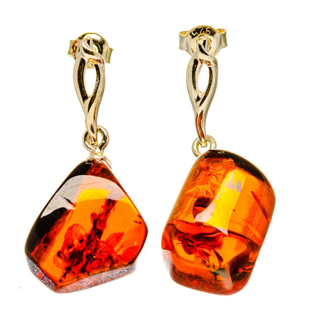 Amber drop earrings with silver hoops and dark orange teardrop stones