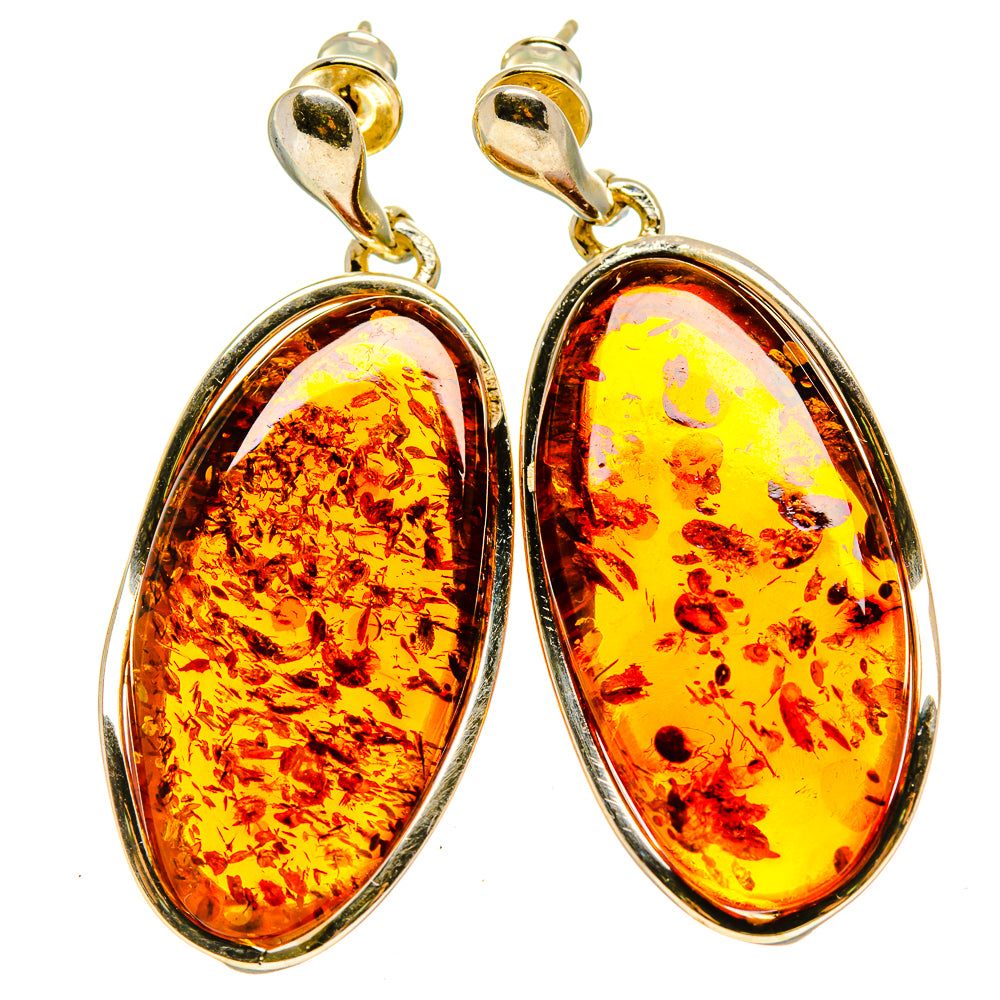 Gold-tone oval hoop drop earrings with amber-colored teardrop stones and silver setting