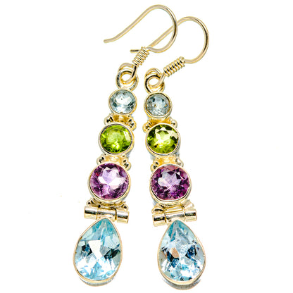 Gold-tone multicolor gemstone drop earrings with blue teardrops, purple rounds, and green accents