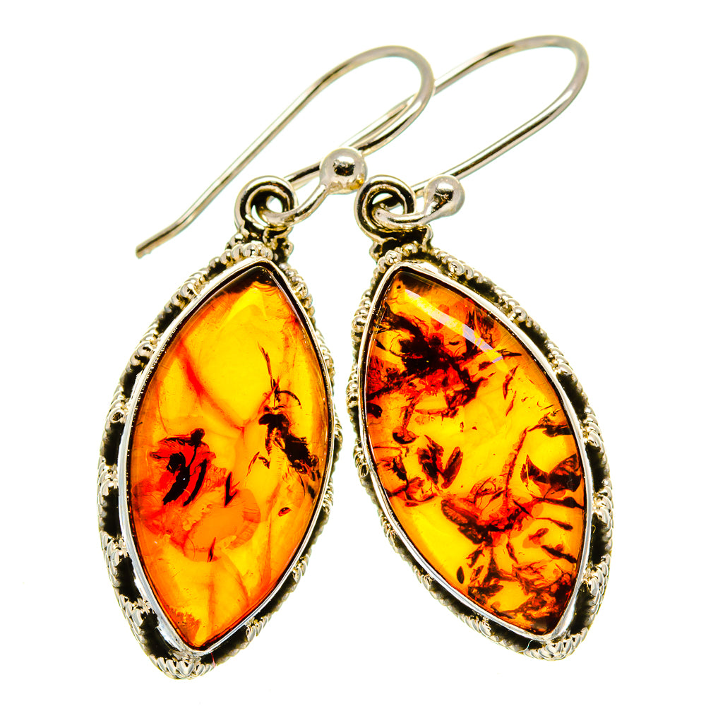 Teardrop amber earrings with gold-tone hooks and marbled yellow-orange stone.