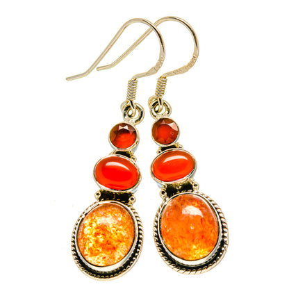 Silver-tone drop earrings with red-orange carnelian cabochons and shepherd hook backs