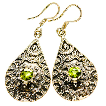 Ornate peridot teardrop earrings in gold-tone filigree with green gemstone drops