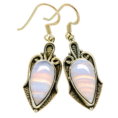 Teardrop stone drop earrings with black ornate bezel and iridescent white centers