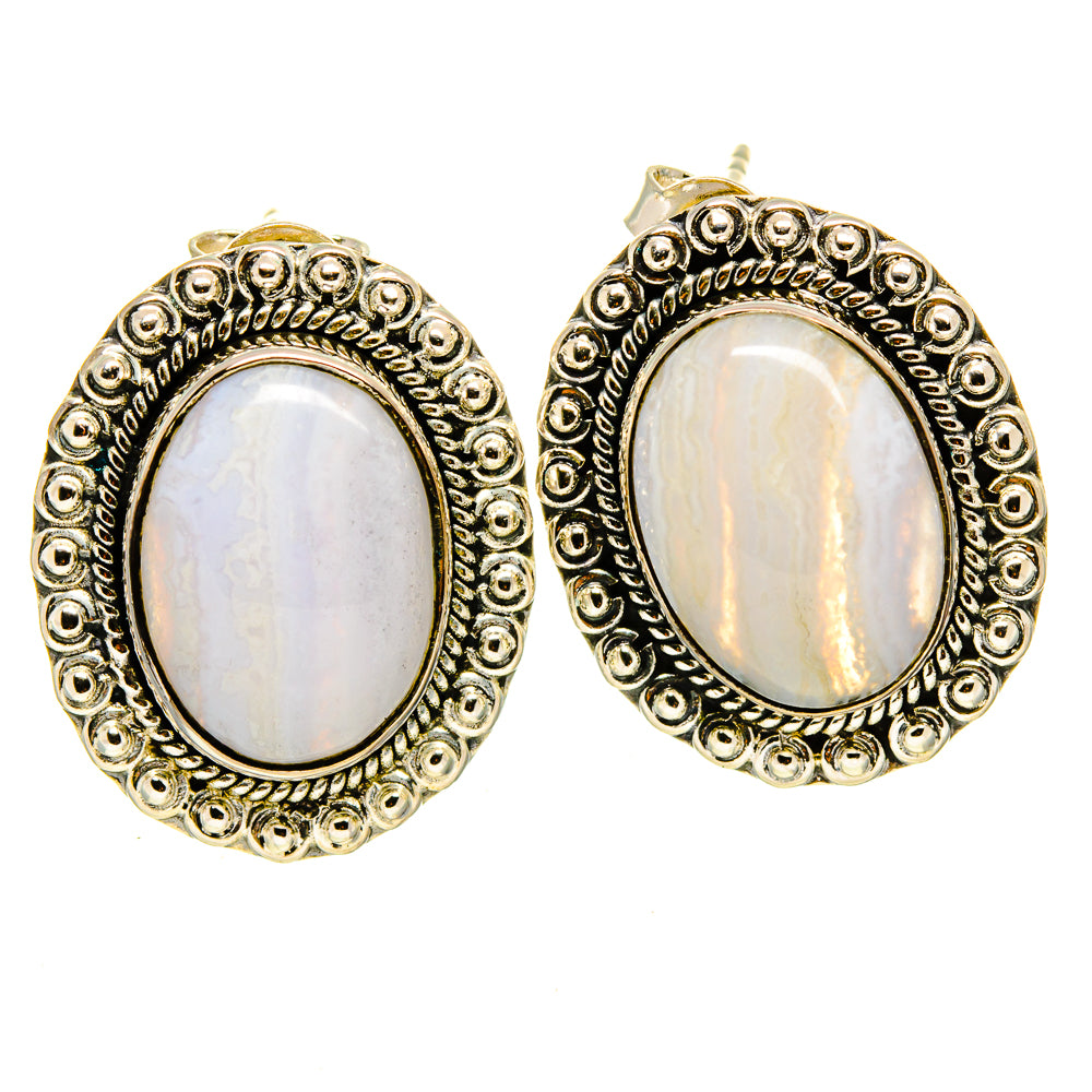 Oval stone earrings with ornate circular filigree bezel and gold-tone setting