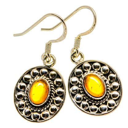 Round carnelian earrings, 925 sterling silver hooks, beaded border and amber center.