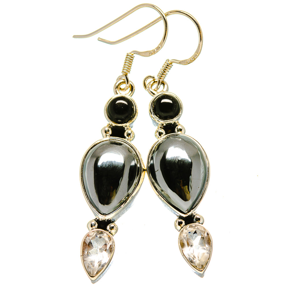 Pair of silver-tone drop earrings with black round beads, oval metal drops, and clear teardrops