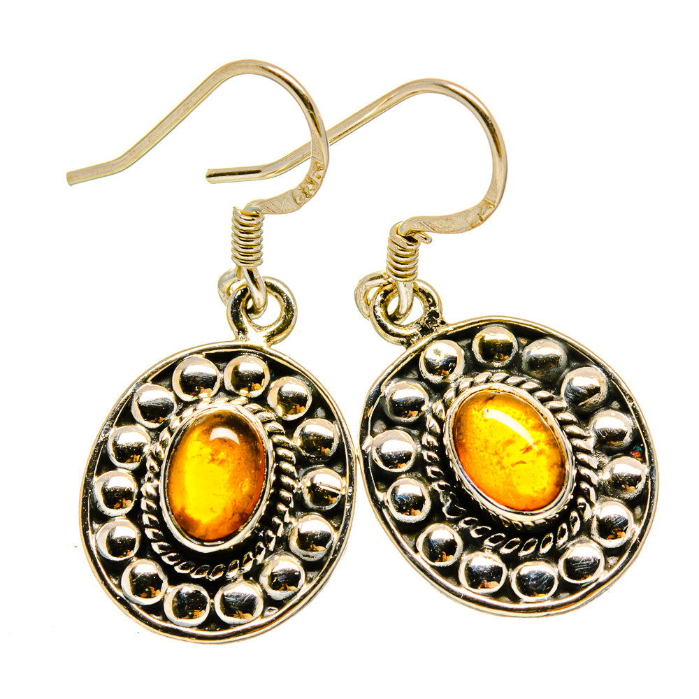 Carnelian cabochon earrings with ornate round border, fishhook backs, gold-tone setting