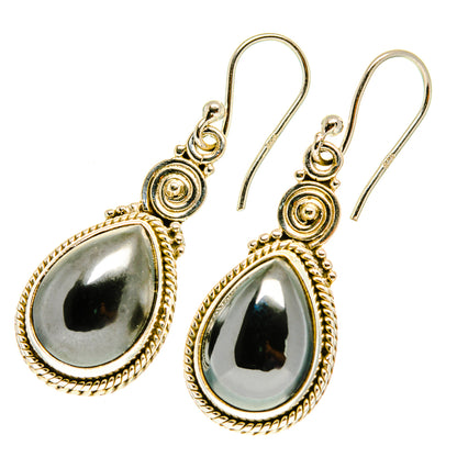Gold-tone teardrop hematite earrings, scalloped bezel, lever hooks